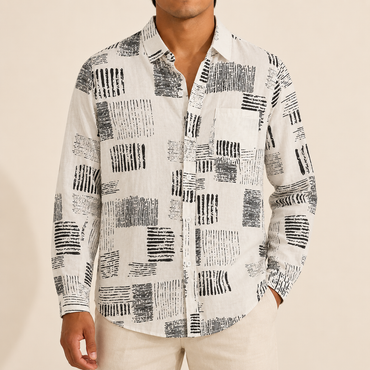 Model wearing a white long-sleeve shirt with black abstract blocks and a chest pocket
