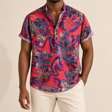 Model wearing a red band-collar shirt with purple and navy leaves