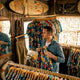Man shopping for colorful Hawaiian shirts in boutique