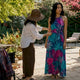 Stylist adjusting tropical print dress outdoors