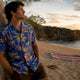 Man wearing cobalt blue Dan Flashes shirt on boardwalk