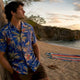 Man wearing cobalt blue Dan Flashes shirt on boardwalk
