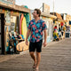 Man at tropical beach wearing Dan Flashes shirt