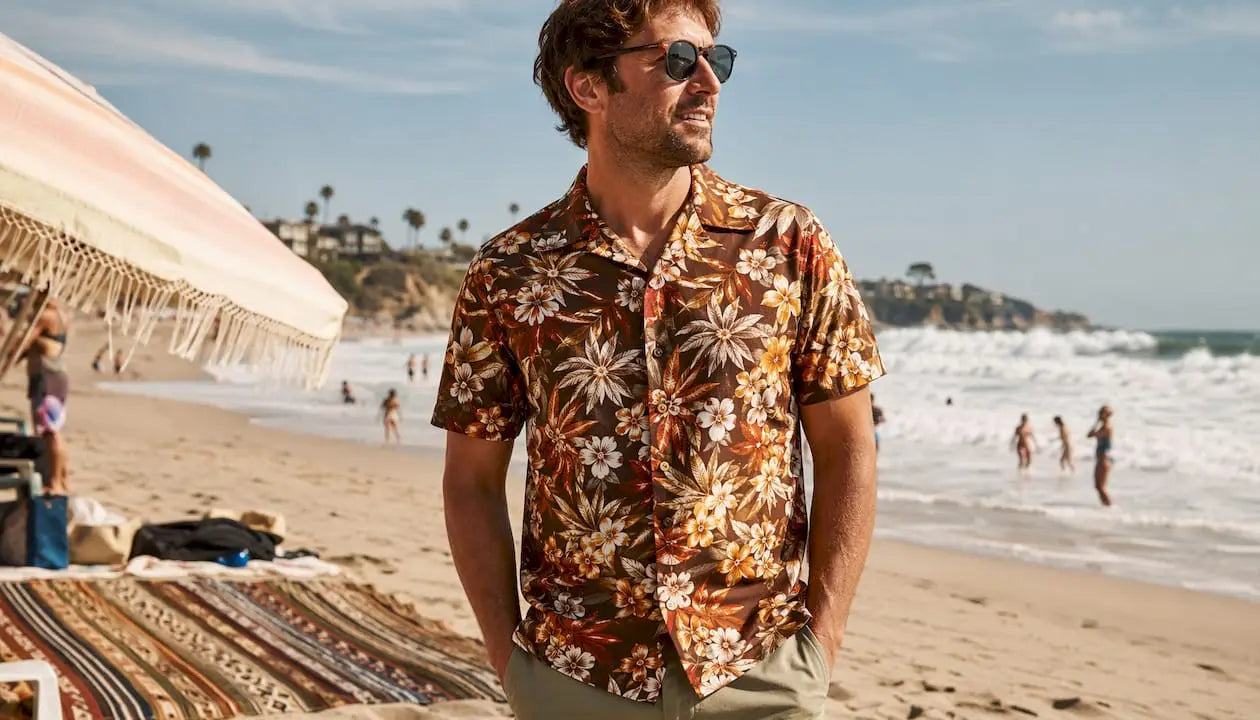 Man wearing Dan Flashes floral Hawaiian shirt on beach