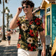 Man wearing Dan Flashes tropical shirt on beach