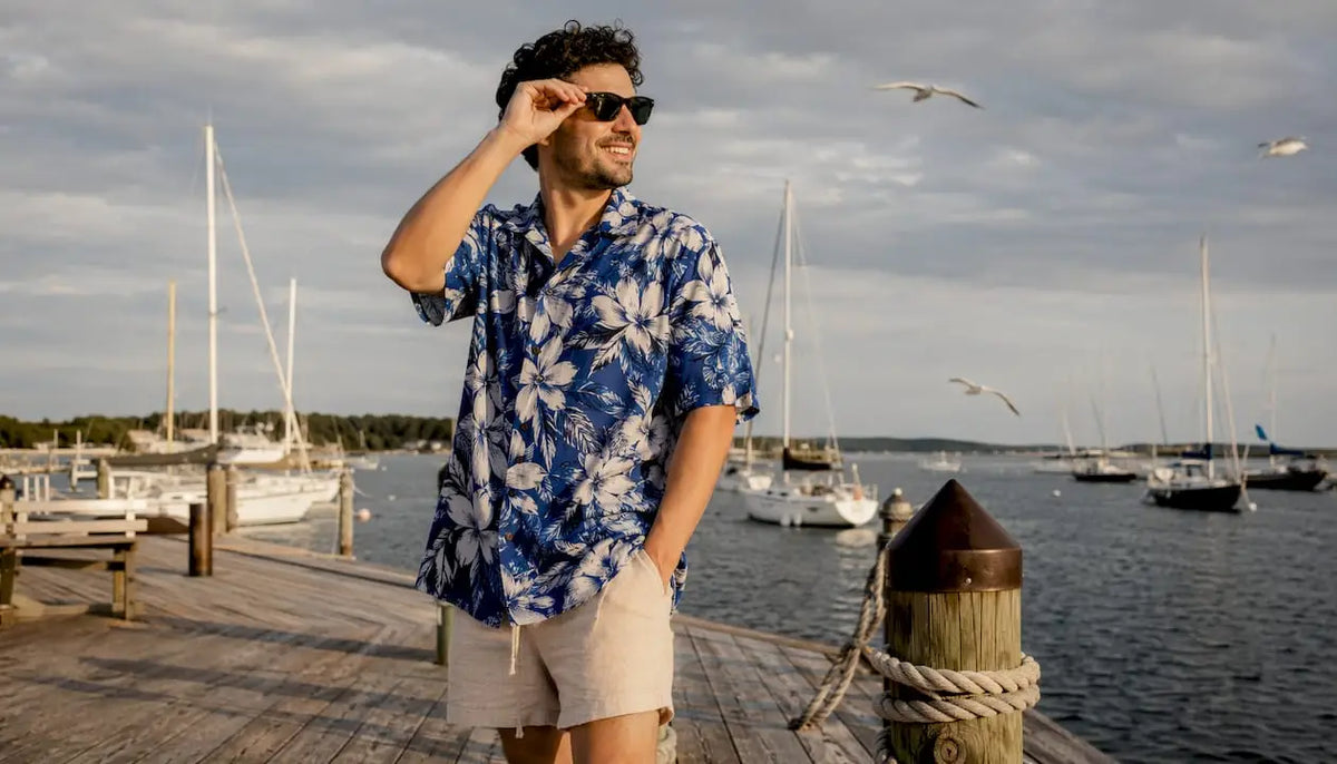 Man wearing Dan Flashes loose fit Hawaiian shirt on beach boardwalk