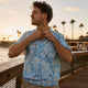 Man wearing Dan Flashes Hawaiian shirt on beach boardwalk