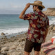 Man wearing Dan Flashes bold floral beach shirt