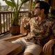 Man wearing Dan Flashes bold patterned shirt by poolside