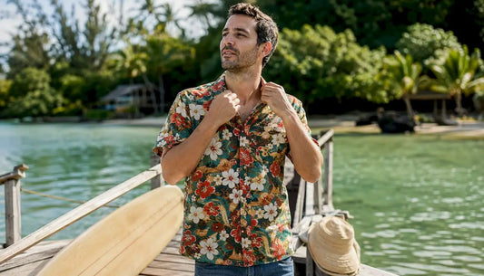 Man adjusting collar of Dan Flashes canoe shirt on boardwalk