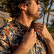 Man adjusting Danflashes Hawaiian shirt collar