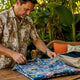 Man folding Dan Flashes shirt for storage
