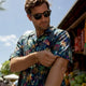 Man adjusting sleeve of moisture-wicking Hawaiian shirt