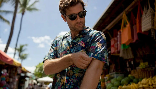 Man adjusting sleeve of moisture-wicking Hawaiian shirt
