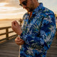 Man adjusting Dan Flashes shirt cuff on beach