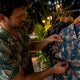 Man adjusting pattern alignment on Hawaiian shirt