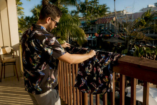 Man air drying a Hawaiian shirt outdoors