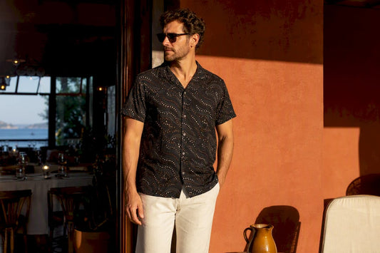 Man wearing dark patterned shirt in sunlight