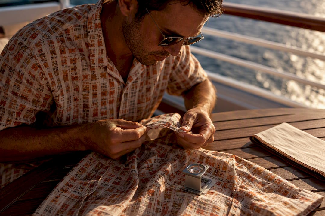 Man inspecting certified shirt construction