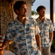 Adult men wearing coordinated vacation shirts