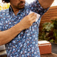 Man preventing sweat marks on patterned shirt