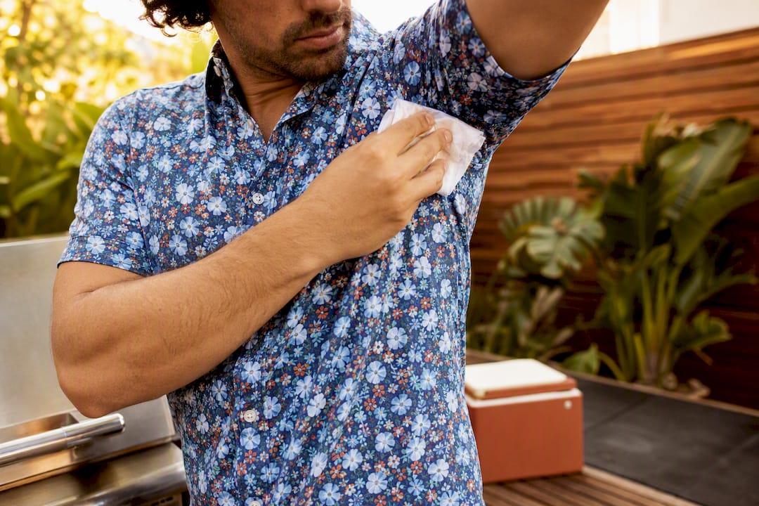 Man preventing sweat marks on patterned shirt