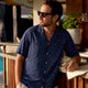 Man wearing Dan Flashes summer shirt poolside
