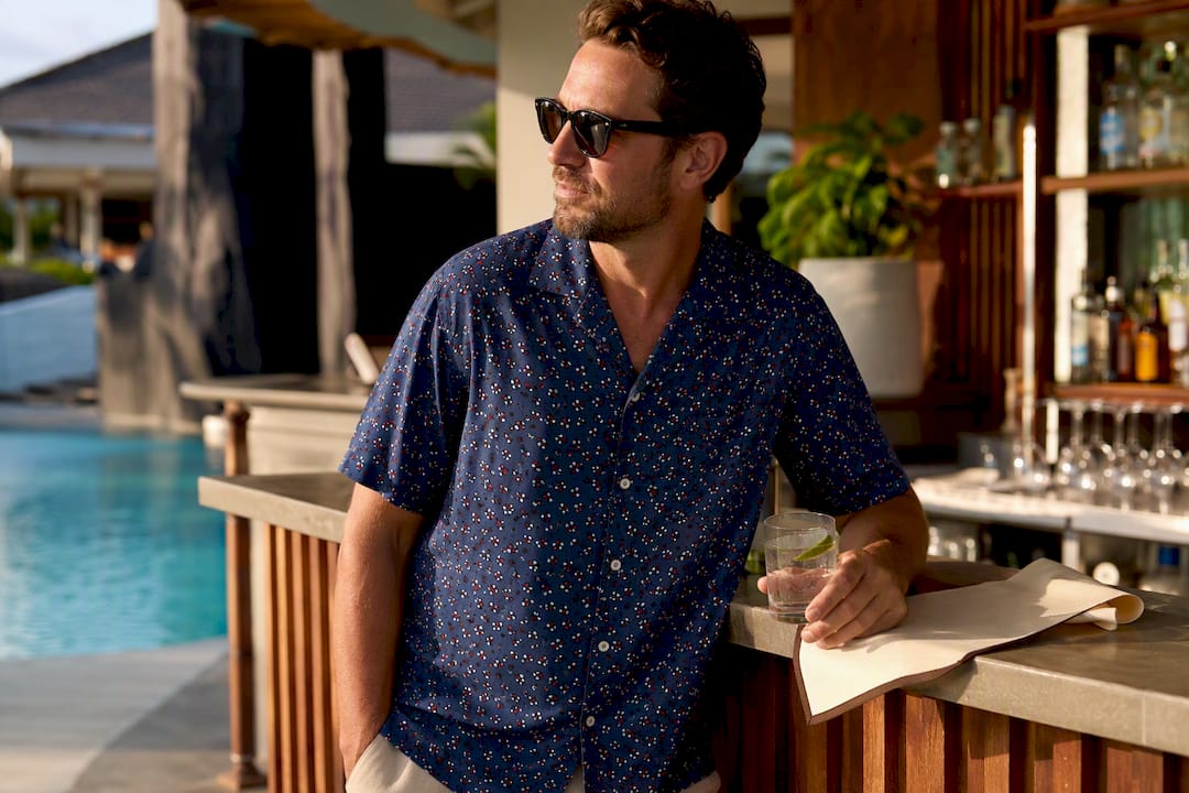 Man wearing Dan Flashes summer shirt poolside