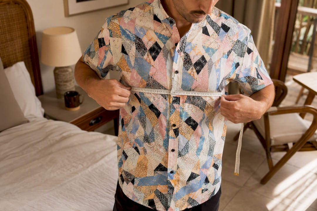 Man measuring chest of Dan Flashes shirt