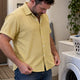 Man checking a Dan Flashes shirt after washing