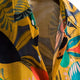 Yellow shirt with a multicolored botanical pattern and pointed collar
