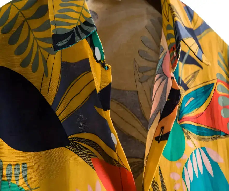 Yellow shirt with a multicolored botanical pattern and pointed collar