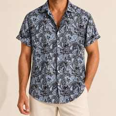 Model wearing a gray and black paisley short-sleeve button-up shirt