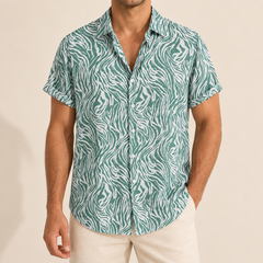 Model wearing a green and white animal-stripe short-sleeve button-up shirt