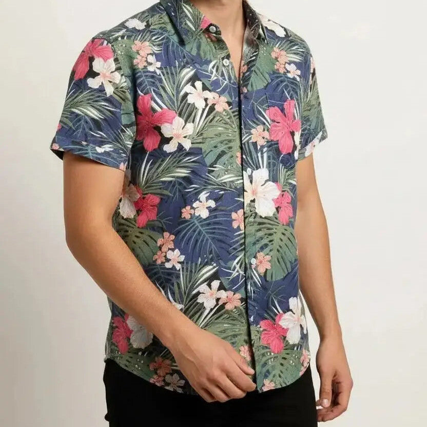Man wearing a navy shirt with green leaves and red and white flowers
