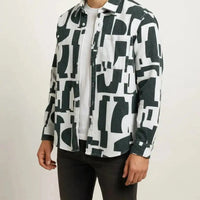 Man wearing a black and white patterned long sleeve shirt - Dan Flashes