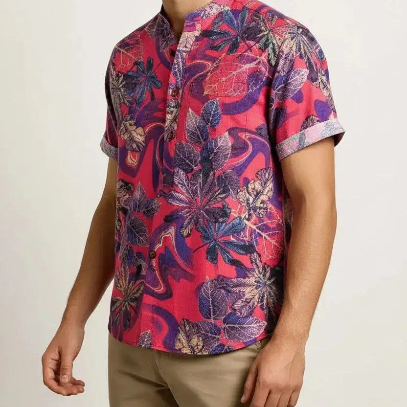 Man wearing a red and purple botanical print short-sleeve shirt