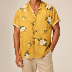 Man wearing a yellow floral shirt available in extended sizes - Dan Flashes