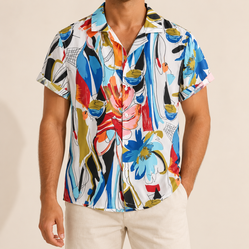 Model wearing a white short-sleeve shirt with colorful abstract botanical patterns