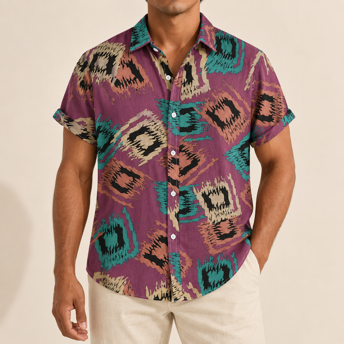 Model wearing a purple short-sleeve shirt with teal and tan abstract diamond motifs