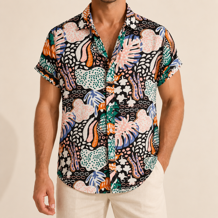 Model wearing a black short-sleeve shirt with colorful abstract leaf patterns