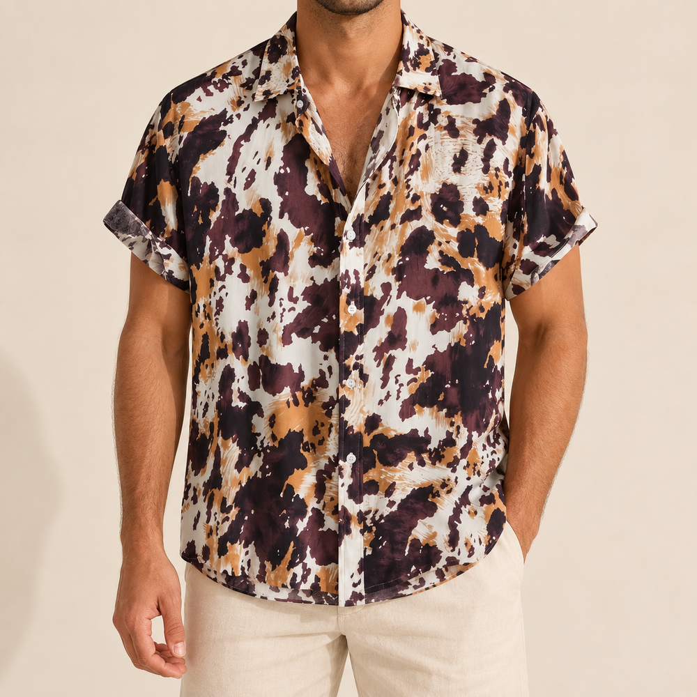Model wearing a cream, brown and ochre mottled short-sleeve button-up shirt