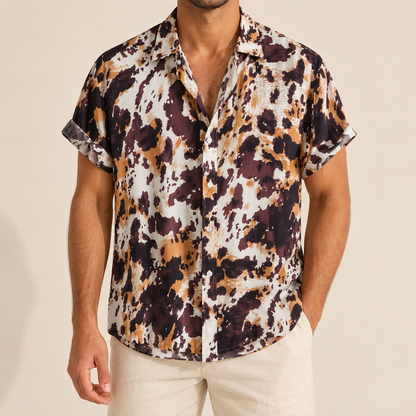 Model wearing a cream, brown and ochre mottled short-sleeve button-up shirt