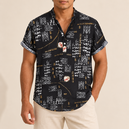 Model wearing a black short-sleeve band-collar shirt with white geometric motifs