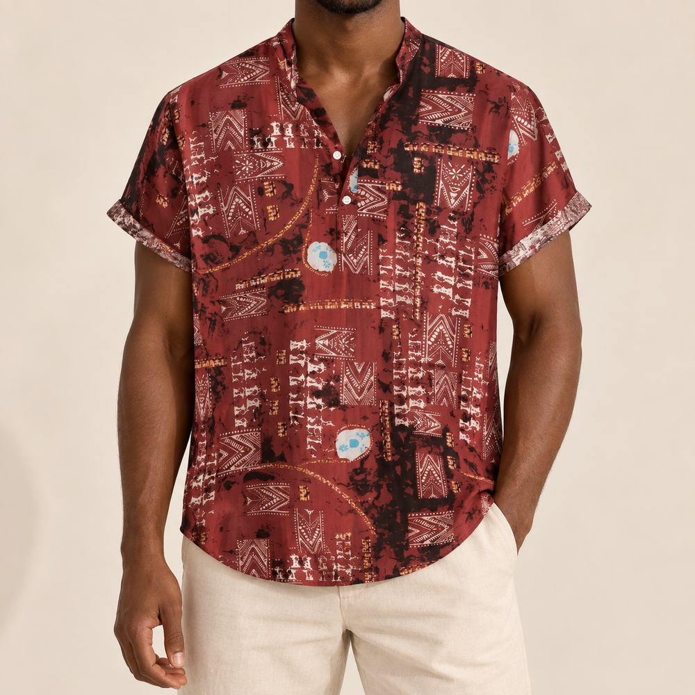 Model wearing a burgundy short-sleeve shirt with abstract panel motifs