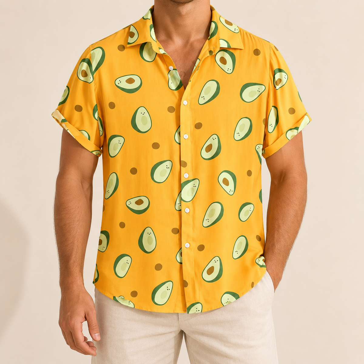 Model wearing a yellow short-sleeve button-up shirt with green avocado prints