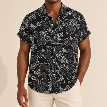 Model wearing a black short-sleeve shirt with white outline flowers