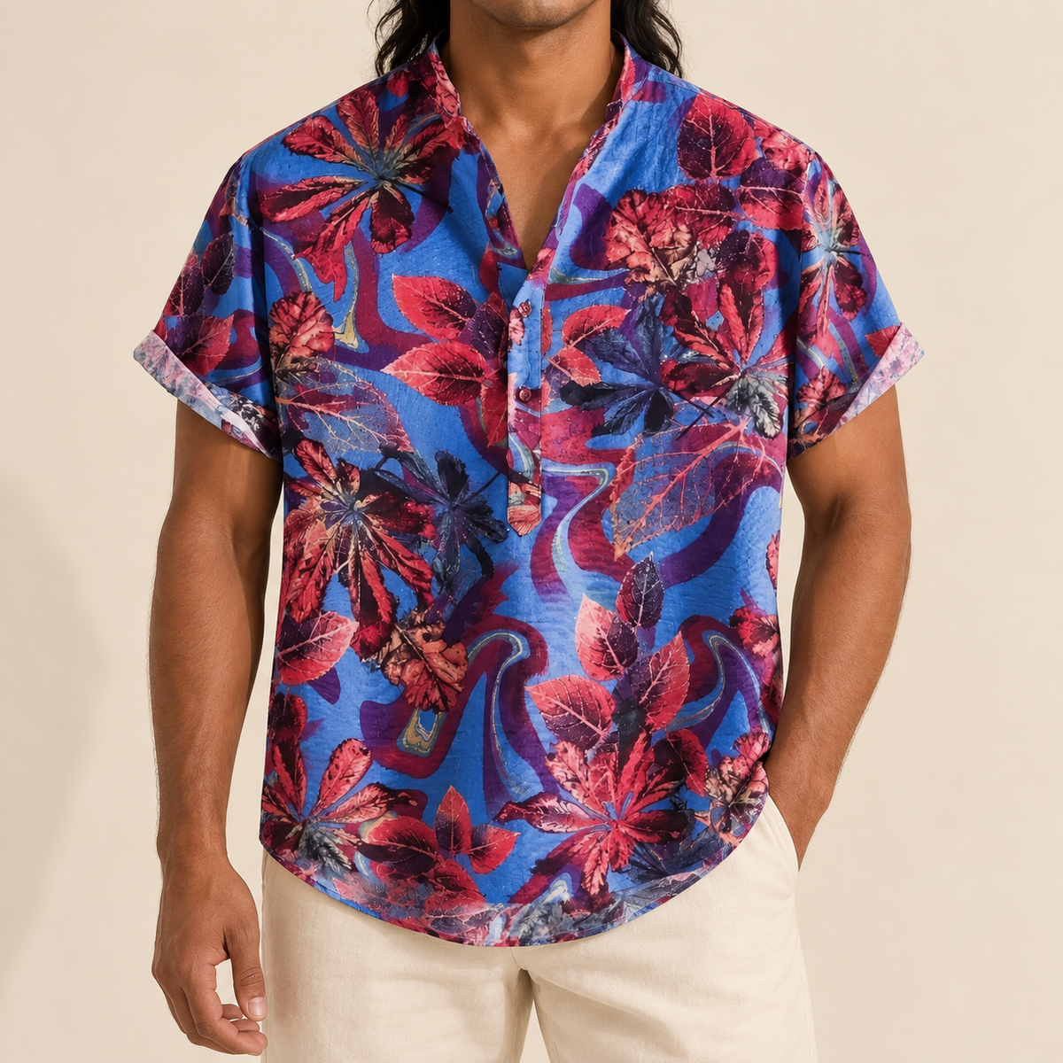 Model wearing a blue shirt with red and purple abstract botanical patterns