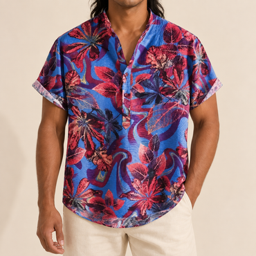 Model wearing a blue shirt with red and purple abstract botanical patterns