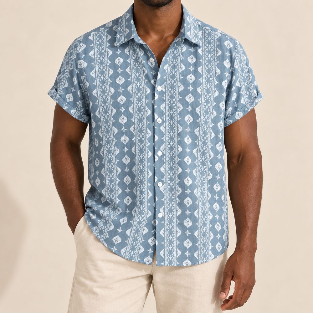 Model wearing a blue short-sleeve shirt with white geometric stripes